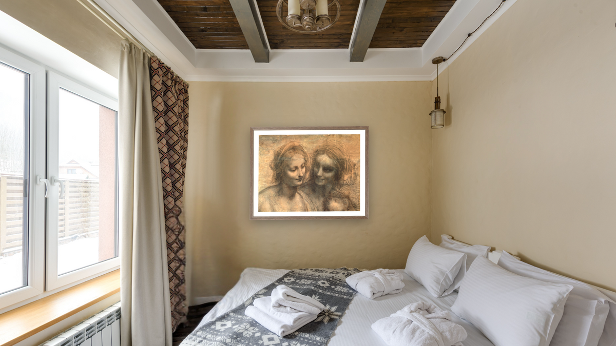 Detail of the Heads of the Virgin and St. Anne, from The Virgin and Child with SS. Anne and John the Baptist by Leonardo da Vinci, shown at 30 × 40 in (76.2 × 101.6 cm) in Arber Light Walnut, hotel guest room