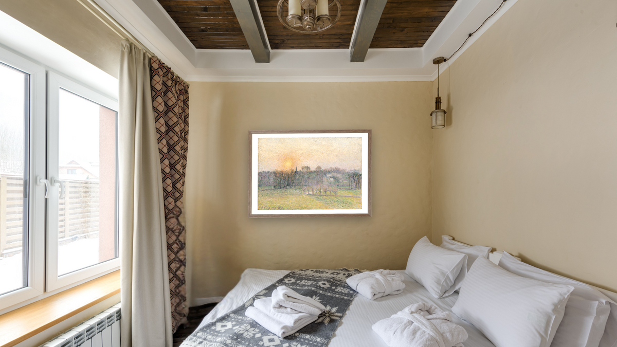 Sunset, Bazincourt by Camille Pissarro, shown at 28 × 42 in (71.1 × 106.7 cm) in Arber Light Walnut, hotel guest room