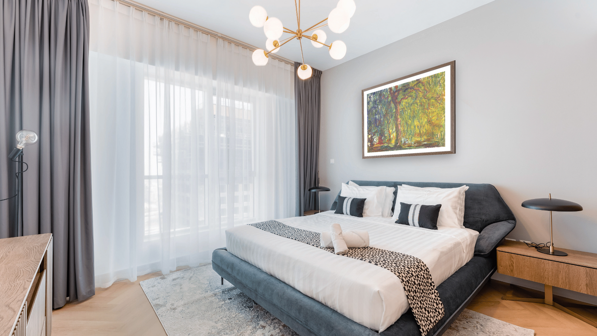 Weeping Willow by Claude Monet, shown at 33 × 40 in (83.8 × 101.6 cm) in Arber Light Walnut, hotel guest room