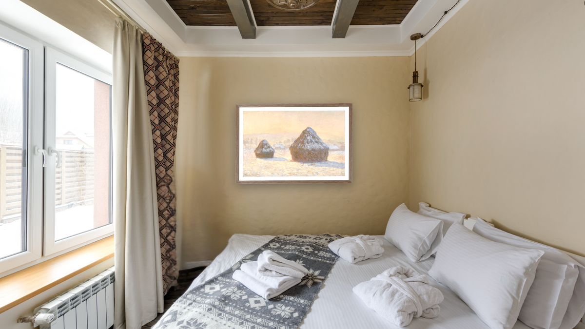 Wheatstacks, Snow Effect, Morning (Meules, Effet de Neige, Le Matin) by Claude Monet, shown at 27 × 42 in (68.6 × 106.7 cm) in Arber Light Walnut, hotel guest room