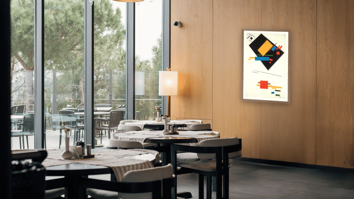 Suprematist Painting (with Black Trapezium and Red Square), shown at 26 × 42 in (66 × 106.7 cm) in Arber Light Walnut, restaurant