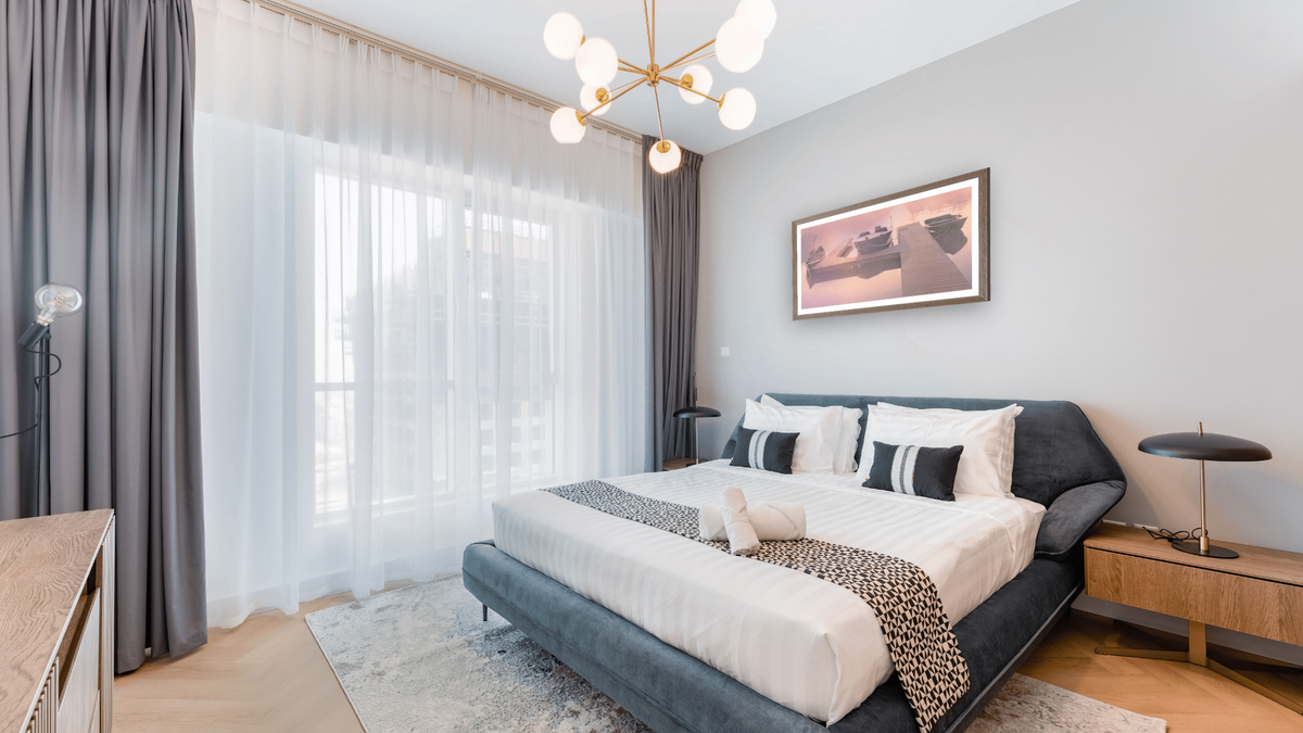 Finches Dock by Kirsten Söderlind, shown at 21 × 40 in (53.3 × 101.6 cm) in Arber Light Walnut, hotel guest room
