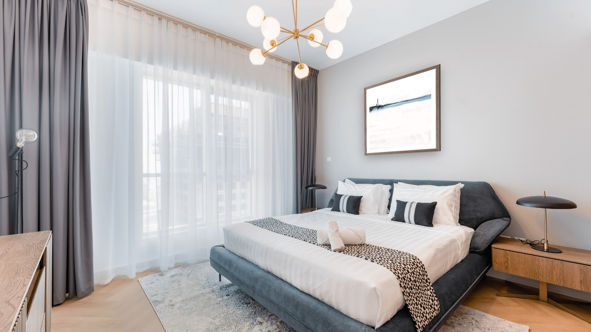 Horizon by Dan Hobday, shown at 32 × 32 in (81.3 × 81.3 cm) in Arber Light Walnut, hotel guest room