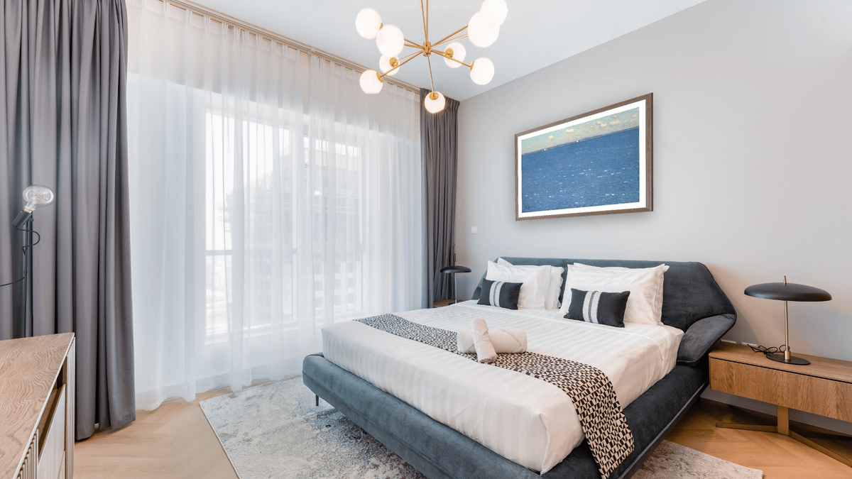The West Wind, Isles of Shoals by Childe Hassam, shown at 29 × 42 in (73.7 × 106.7 cm) in Arber Light Walnut, hotel guest room