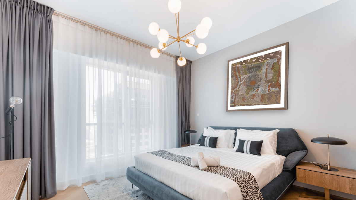Warlugulong by Tim Leura Tjapaltjarri, shown at 32 × 32 in (81.3 × 81.3 cm) in Arber Light Walnut, hotel guest room