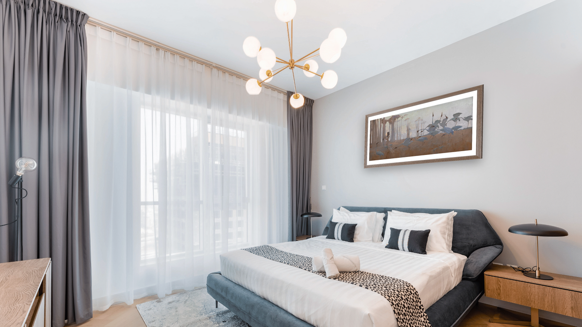 Spirit of the Plains by Sydney Long, shown at 20 × 40 in (50.8 × 101.6 cm) in Arber Light Walnut, hotel guest room