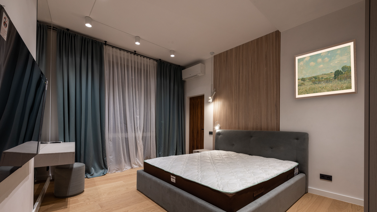 Meadow by Alfred Sisley, shown at 30 × 40 in (76.2 × 101.6 cm) in Arber Light Walnut, hotel guest room