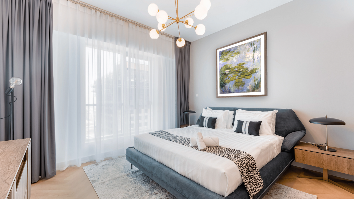 Nympheas by Claude Monet, shown at 36 × 40 in (91.4 × 101.6 cm) in Arber Light Walnut, hotel guest room
